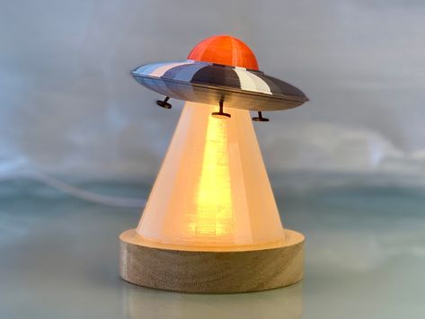 "Important Notice: My processing time is currently 10 - 12 business days because I will be out of the shop. This item will not arrive before Christmas but shortly after but I think this item is worth the wait. Processing time will be back to normal when I return :-) Thank you! \"I want to believe!\" This super cute retro UFO LED lamp will look amazing on your desk. The beam is semitransparent and can be opened so you can put or tape on what you want the little UFO to beam up. Try a toy cow or a Intense Art, Spacex Starship, 50's Style, Cool Lamps, Kids Area, Dream Room Inspiration, Retro Futuristic, Space Theme, Iconic Design