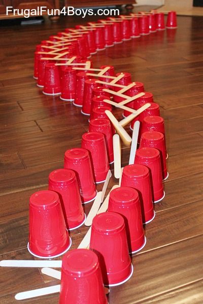 Simple Popsicle Stick Chain Reactions - Frugal Fun For Boys and Girls Domino Chain Reaction, Rube Goldberg Projects, Popsicle Craft, Goldberg Machine, Rube Goldberg Machine, School Age Activities, Stem Classes, Rube Goldberg, Science Labs