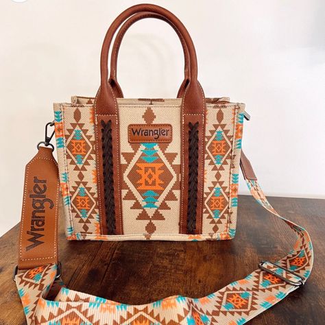 Wrangler Aztec/Southwestern Print Small Canvas Tote/ Tan. Condition Is New With Tags. Shipped With Usps Ground Advantage. Made Of Canvas And Pu Leather Trimmed, This Tote/Crossbody Has: Allover Aztec Pattern Print On Canvas Whipstitch Details Wrangler Logo Applique On The Front Top Zipper Closure Inside Of The Bag Includes A Zippered Pocket And 2 Open Pockets Double Round Handle (Drop : 5.75") Detachable/Adjustable Crossbody Strap Included 10.5" X 5" X 8.5" (Crossbody Strap 46" ) Western Bags, Southwest Pattern, Country Outfit, Western Bag, Cute Luggage, Chic Purses, Western Vibes, Southern Outfits, Western Purses