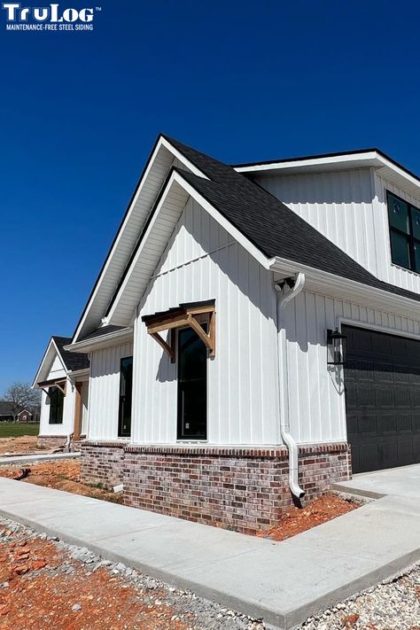 Brick And Board And Batten Exterior Ranch, White Metal Siding Farmhouse, White Hardie Board With Brick, Red Brick White Board And Batten, Brick And Metal Siding Exterior, White Farmhouse Brick Foundation, Modern Farmhouse Exterior Colors White, White Barndo With Black Roof, Board And Batten And Vinyl Siding