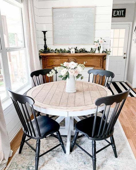 Dining set with black spindle dining chair and two-toned round white pedestal table is arranged in front of a stained wood buffet table. The buffet table leans against a white shiplap wall next to a white window. Black Spindle Chairs, Spindle Chairs, Farmhouse Breakfast Nook, Breakfast Nook Table, Nook Table, White Shiplap Wall, Spindle Dining Chair, Diy Shiplap, Farmhouse Dining Room