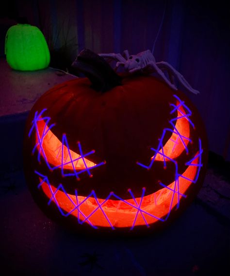 I used uv reactive yarn to thread across the eye and mouth openings on the pumpkin. Hung a black light, and voila! Pumpkin With Mouth Sewn Shut, Pumpkin Mouth, Pumkin Carving, Creative Pumpkin Carving, Amazing Pumpkin Carving, Glow Paint, 2024 Halloween, Creative Pumpkins, Halloween Pumpkins Carvings