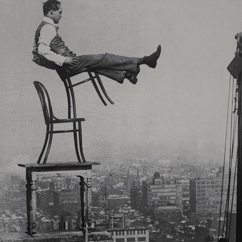 c. 1920s, Man Balancing atop 20-Story Building; chairs by Michael Thonet (1796—1871)  Perched on a girder at the edge of a building under construction, a confident daredevil balances on the back legs of a chair atop another chair set on a table, from a height of 20 stories - without a safety net. Photo by George Rinhart New York Rooftop, Thonet Chair, Urban Culture, Cafe Chairs, Benjamin Franklin, Modern Urban, Le Corbusier, Tour Eiffel, A Chair