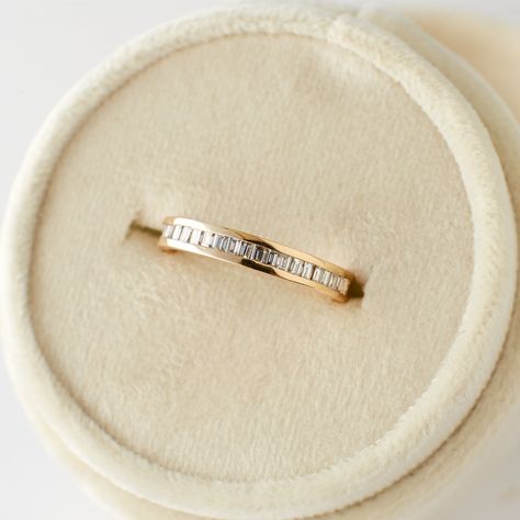 Made for the traditionalists, the Ari band is a classic channel-setting design that compliments a variety of engagement and just-because rings. Set with 22 baguette diamonds around the band, this half-eternity ring adds incredible sparkle to any stack. DETAILS: Set with approximately 0.44 carats of natural white diamonds with clarity SI1 or better and color H or better; total carat weight of approximately .32 carats. Band width of 3mm Made of 14 karat solid gold Please allow 4 weeks for your rin