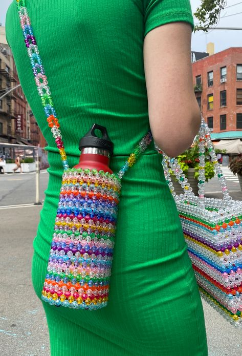 A crossbody bag designed to keep you hands-free! Fits a standard sized water bottle with ease. This bag is made by hand! Please allow up to 3 weeks from the order date for your item to arrive! Beaded Water Bottle Holder, Crochet Bottle Holder, Cover Design Ideas, Crochet Water Bottle, Susan Alexandra, Crochet Water Bottle Holder, Bead Bottle, Denim Bag Diy, Hand Beaded Bag