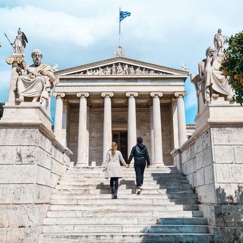 Travel couple posing in front of Academy of Athens, Greece Famous Photos, Walking Routes, Classic Architecture, Love Photo, Acropolis, Best Photo, Booking Hotel, Athens Greece, Love Photos