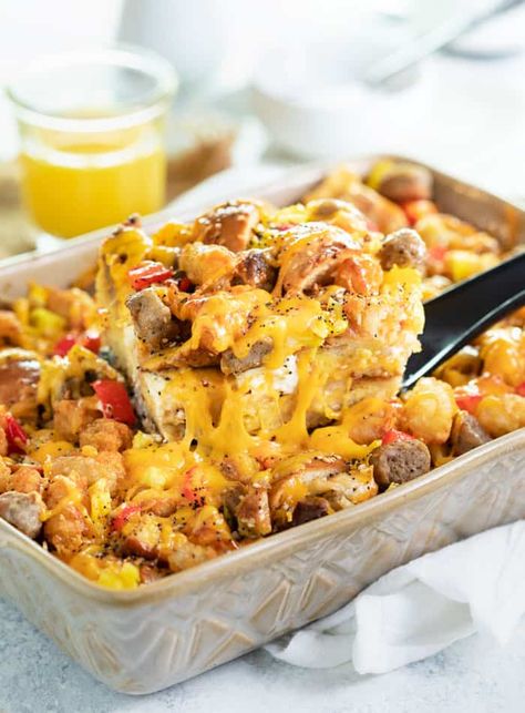 A spatula pulling up a slice of everything bagel breakfast casserole from casserole dish with orange juice in background. Everything Bagel Breakfast Casserole, Bagel Casserole, Bagel Breakfast Casserole, Everything Bagel Breakfast, Breakfast Eggs Scrambled, Bagel Breakfast, Overnight Breakfast Casserole, Breakfast Bagel, Breakfast Casserole Sausage