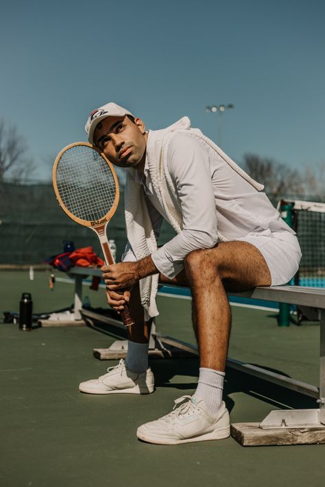 Man sitting on a be shot at a tennis court getting ready to play Tennis Men, Sports Outfit, Tennis Men Photoshoot, Tennis Poses, Tennis Pictures Poses, Tennis Poses Photo Ideas, Tennis Court Photoshoot Men, Male Tennis Photoshoot, Tennis Shoot