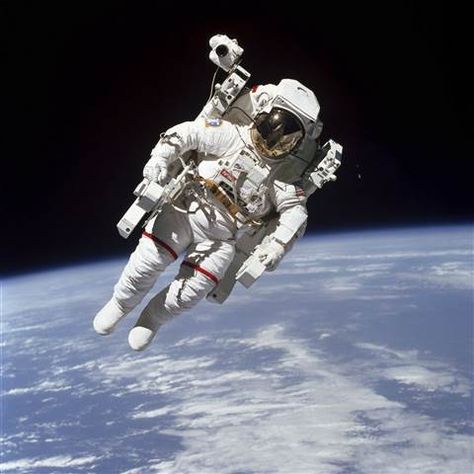 Image: This Feb. 7, 1984 photo made available by NASA shows astronaut Bruce McCandless II, participating in a spacewalk a few meters away from the cabin of the Earth-orbiting space shuttle Challenger, using a nitrogen-propelled Manned Maneuvering Unit. Background Stars, Space Shuttle Challenger, Nasa Missions, Sky Stars, Nasa Astronauts, Astronauts In Space, Space Photos, Apollo 11, Space Pictures