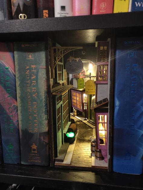 Book Nook Bookshelf Insert Dioramas | Apartment Therapy Diagon Alley Book Nook, Harry Potter Book, Bookshelf Art, Diagon Alley, Book Nook, Adult Crafts, World Of Books, Miniature Books, Miniature Crafts