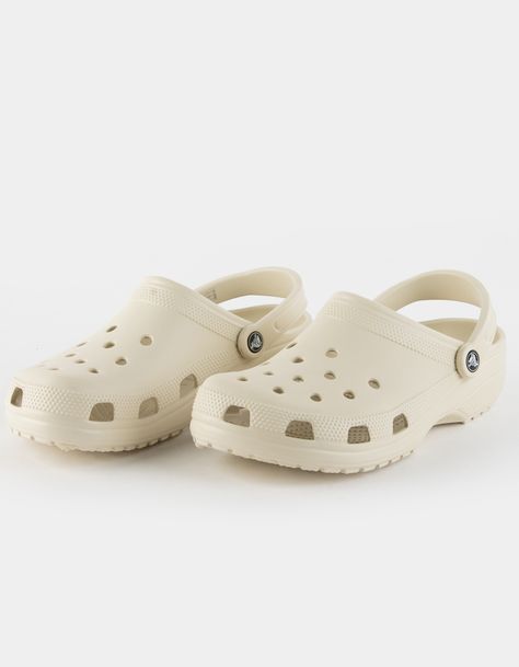 Crocs Classic Unisex Clogs. Easy On, Easy Off! The Classic Clog Offers Amazing Comfort And Support, Thanks To The Light, Durable Croslite™ Material And Molded Design. Customize Your Crocs Clog However They Like; Ventilation Holes Accommodate Jibbitz™ Brand Charms. Pivoting Heel Straps For A More Secure Fit. Easy To Clean. Iconic Crocs Comfort™: Lightweight. Flexible. 360-Degree Comfort. Imported. Nude Crocs Clogs, Crocs Crocs Shoes, Crocs Png Aesthetic, Crocs Cream Color, Off White Crocs, Creme Crocs, Fall Crocs Shoes, Neutral Crocs, Stucco Crocs