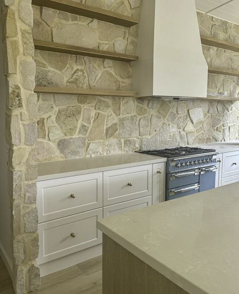 Charlotte is one of our most popular stones! It has so many different looks. Just by mass grouting this stone feature wall, it instantly adds warmth and character to the kitchen, perfectly complementing the clean lines and classic elements. A timeless touch that transforms the heart of the home. 🏡✨  Stone: Charlotte Install: @feature_stone_victoria   #CharlotteStone #MassGrouted #StoneDesign #KitchenInspiration #NaturalBeauty #InteriorDesign Building Cladding, White Cupboard, Bluestone Pavers, Stone Feature Wall, Sandstone Wall, Cladding Systems, Dream Interior, Stone Kitchen, Kitchen Splashback