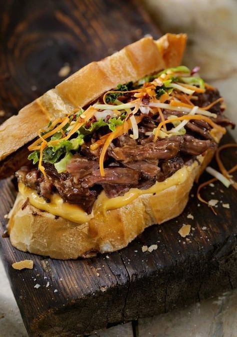 Globally inspired, this warm dinner-sandwich, reminiscent of Vietnamese Banh Mi, has been adapted from a recipe developed by Mexican Chef Josefina Santacruz. Short Rib Sandwich Recipe, Braised Beef Sandwich, Short Rib Sandwich, Veggies Roasted, Vietnamese Banh Mi, Garlic Mayonnaise, Rib Sandwich, Dinner Sandwich, Steak Sandwich Recipes