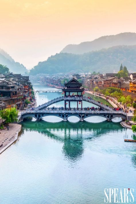 Bridge over a blue river. Houses line either side of the river. Fenghuang Ancient Town, Credit Suisse, 50 Million, China Travel, The Locals, Over 50, Phoenix, The Next, China