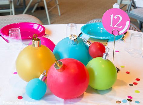 DIY Christmas Table Decor Ideas. Christmas Balloon Tablescape that looks like big ornaments. Great cheap centerpiece for your Christmas party. Fun idea for a kids table or a big event. Easy DIY Christmas ornaments w. balloons. FREE template & SVG included to make ornament toppers. BE creative, cheer up your holiday table settings w. multi colored plates and balloons in non-traditional colors. Golds, reds, hot pink, bright blue, & light green. #christmas #tablescape #balloons Press Print Party! Centerpiece Christmas Diy, Christmas Party Decorations Table, Cheer Christmas Party, Balloon Centerpieces Diy, Holiday Party Centerpieces, Christmas Party Centerpieces, Party Centerpieces Diy, Cheap Centerpieces, Christmas Centerpieces Cheap