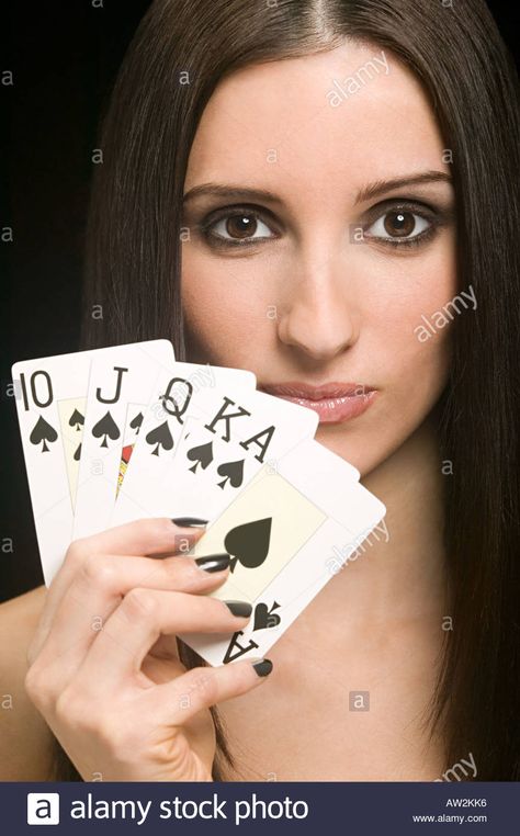 Woman holding playing cards Stock Photo Hand Holding Deck Of Cards Drawing, Shuffling Cards Pose Reference, Deck Of Cards Photoshoot, Person Holding Cards Reference, Holding Cards Pose Reference, Holding Cards Reference, Hand Holding Playing Cards, Gentlemen Guide, Card Photoshoot