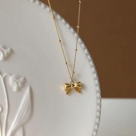 Elevate your style with these trendy gold necklaces! 🌟 Perfect for everyday wear or as a thoughtful gift for someone special. Find your favorite design now! #GoldNecklace #DaintyJewelry #TrendyStyle ✨ Grad Ideas, Bow Pendant, Necklace Trendy, Tiny Bow, Subtle Elegance, Bow Necklace, Dress Indian, Bow Jewelry, Dainty Gold Necklace