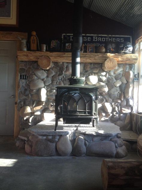 River Rock Hearth Wood Stoves, Stone Hearth Wood Stove, River Rock Wood Stove Surround, Stone Hearth For Wood Stove, Rock Wall Behind Wood Stove, Wood Stove With Mantle, Diy Stone Wall Interior, Log Mantle, Pellet Stove Hearth