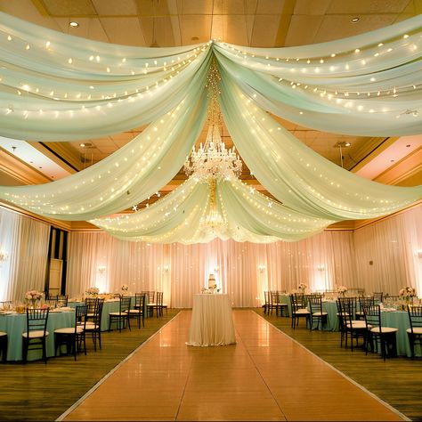 PRICES MAY VARY. 6-Pack Ceiling Drapes for Weddings: 6 panels sage green ceiling drapes for weddings, each ceiling draping fabric measure for 5 feet width x 10 feet length. Come with curtains light string, turn any empty room into a party-ready venue is to decorate with beautiful, flowy layers of floor to ceiling drapes! Wedding Ceiling Drapes: Made of WRINKLE FREE premium sheer tulle fabric, best fabric for ceiling draping, adding a very special ambiance, mood, feel, design and tone to the spac High Ceiling Decorating Wedding, Hanging Drapes From Ceiling Wedding, Mint Green And Gold Wedding Theme, Sage Green Decor Quince, Inside Wedding Decor, Whimsical Glam Wedding, Sage Quinceanera Decorations, Sage Green And Lavender Quinceanera, Event Party Decor