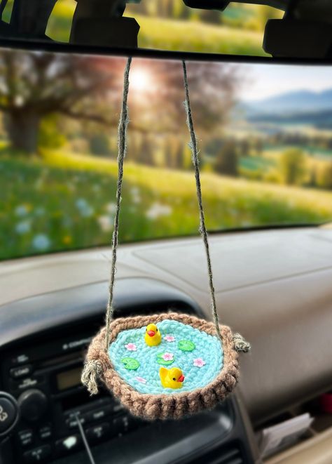 Handmade crochet ufo accessory for your car! These duckies are the best companion to add to your car ! (ducky figures not made by me) Crochet Car Mat, Crochet For Car Ideas, Crochet Car Rear View Mirror, Crochet Car Basket Free Pattern, Free Crochet Car Decor Patterns, Free Crochet Patterns Car Accessories, Crochet Car Storage, Things To Crochet For Your Car, Diy Car Accessories Interior