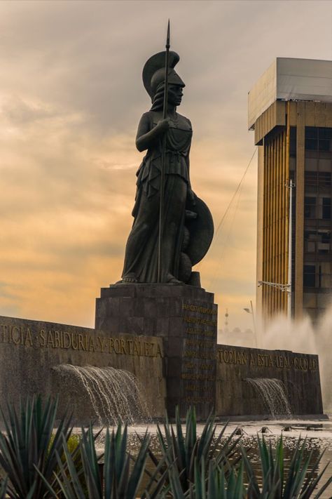 The statue of the Roman Goddess Minerva in Guadalajara, Mexico, was built and assembled in the 1950s. Created by artist Joaquin Arias Mendez, the fountain has become the place for locals to go to celebrate sporting victories. Guadalajara Aesthetic, Guadalajara Cathedral, Minerva Goddess, Goddess Minerva, Iconic Architecture, Lions Gate, Roman Goddess, Roman Mythology, The Fountain