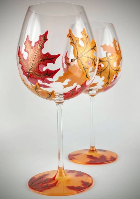 2 Colorful, fall leaf stemmed hand painted wine glasses. Maple leaves in colors of orange and red surround each glass. The base is painted orange on the bottom side, with a few leaves on the top of the base. Each leaf has veins and stems painted in warm, metallic brown.  The glasses are really nice Liquor Bottle Crafts, Wine Glass Designs, Hand Painted Wine Bottles, Decorated Wine Glasses, Hand Painted Glassware, Glass Painting Designs, Hand Painted Glasses, Wine Glass Crafts, Stained Glass Paint