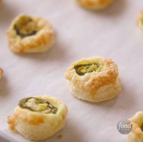 How to Make Ree's Cowboy Cheese Bites | Flaky puff pastry, jalapeño and cheese make the easiest Cowboy Cheese Bites. 🧀 See more from The Pioneer Woman - Ree Drummond, Saturdays at 10a|9c. | By Food Network | Facebook | I'm gonna make a batch of Cowboy Cheese Bites. I'm gonna start with a sheet of puff pastry. So, I'll just grab a rolling pin. I like to get the puff pastry a little bit thinner. I'm gonna help things along by poking little holes with a fork. Now, I've got some melted butter. Okay Jalapeno Bites, Pioneer Woman Ree Drummond, Cheese Bites, Ree Drummond, The Pioneer Woman, Breadsticks, Pin I, How To Make Cheese, Pioneer Woman