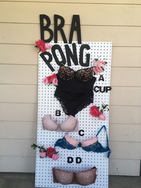 Bra Pong for my dear friend’s bridal shower. I used different bra sizes for this game. Purchased the board at my local hardware store (Home Depot) and used safety pins to hold up the bras. I attracted it onto the bra (straps) and stuck the safety pin into the holes of the board. Bridal Shower Games Ideas, Mastectomy Party, Bra Pong, Bachelorette Party Games Drinking, Trash Party, Lilly Pulitzer Outfits, Diy Bra, Friends Bridal, Mom Party