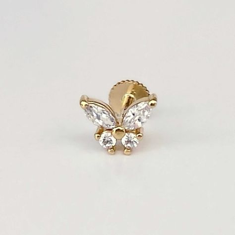 "Our Marquise Butterfly Stud Earring is made with cubic zirconia and 14k solid yellow gold.  It has a flat screw back labret closure to keep it secure and can be worn in your cartilage piercing, helix piercing, conch piercing, or lobe.  This piece looks great in an earring stack mixed with our other labret piercing earrings, or in combination with items from your own collection. Type: Single earring with flat screw back post Post Length : 6.5mm or 8mm Gauge : 18g labret Gemstone : Cubic zirconia Conch Stud, Piercing Conch, Earring Stack, Labret Piercing, Cartilage Stud, Piercing Earrings, Flat Back Earrings, Insect Jewelry, Cartilage Earring