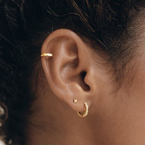 No piercing? No problem! Our Ear Cuff lets you accessorize without the commitment of piercings. And it looks awesome when paired with other hoops and studs! Sold as a single piece. How to wear it: slide the cuff on to your ear the thinnest part (usually toward the top), and then slide it down until it sits snugly.  Cuf Tasteful Ear Piercings, Five Piercings Ears, Stud And Hoop Ear Piercing, Ear Earrings Piercings, Ear Piercings Women, Ear Piercing Women, Single Ear Piercing, Top Ear Piercing, 3 Ear Piercings