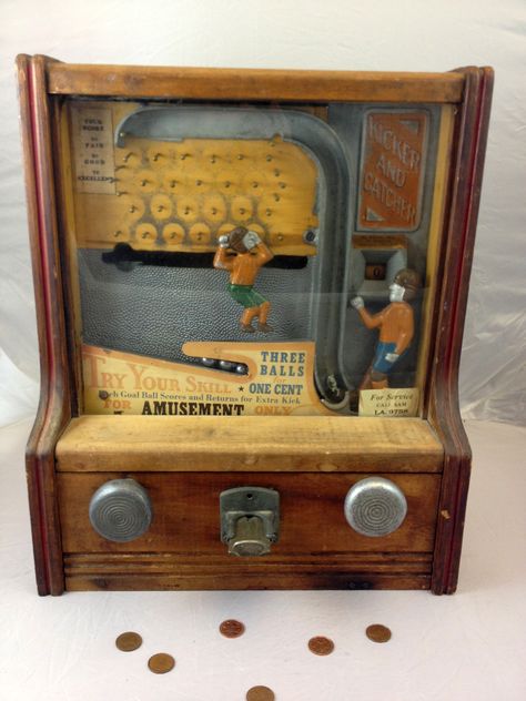 Fabulous 1930s Coin-Operated Penny Arcade Kicker and Catcher Football Game    Behind the glass front panel, a colorful metal kicker and catcher, clad in vintage 1930s football attire are just waiting for the penny to drop. A penny releases three metal balls to the kicker, who then punts them one by one in the direction of the catcher. Before reaching the catcher, each ball must travel through a maze of metal pegs. Game Cabinet, Coin Op Machine, Vintage Slot Machines, Diy Video Game, Vintage Arcade, Arcade Game Machines, Penny Arcade, Coin Operated, Cabinet Of Curiosities