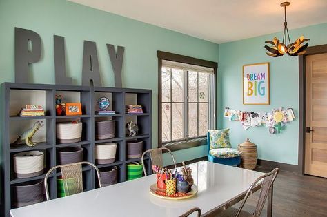 Contemporary playroom features walls painted green fitted with a dark gray framed window next to ... Homework Room, Modern Kids Furniture, Large Wooden Letters, Grey Shelves, Basement Playroom, Office Playroom, Kids' Playroom, Toy Rooms, Playroom Decor