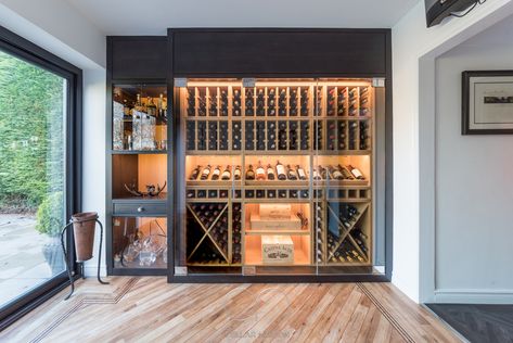 A vision in natural and grey washed oak. This beautifully lit classic wine wall is a perfect example how to execute contrasting joinery.  Cellar Maison are specialists in creating bespoke, climate controlled wine cellars and wine rooms tailored to suit your property, interior design, style and wine collection. Climate Controlled Wine Wall, Wine Walls, Wine Cellar Wall, Wine Room Design, Glass Wine Cellar, Wine Rooms, Wine Closet, Modern Home Bar, Home Wine Cellars