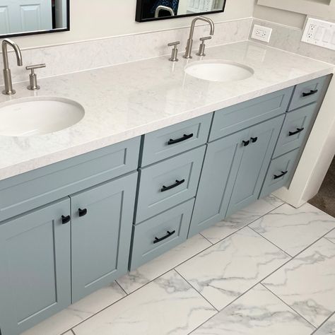 This stunning bathroom remodel is a reminder that beauty can be found in even the most unexpected places. From the elegant marble counter tops to the mesmerizing grey cabinets with a greenish blue undertone, your renovation project could truly be an example of artistry. As you take in the beauty of your newly remodeled bathroom, be reminded that you too have the potential to create something unique and wonderful. Blue Grey Bathroom Cabinets, Bathroom Remodel Gray Vanity, Blue Gray Bathroom Vanity, Blue Cabinets In Bathroom, Bathroom With 2 Sinks, Grey Cabinets Bathroom, Blue Bathroom Cabinets, Grey Marble Countertops, Hacienda Bathroom