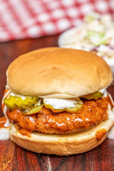 Nashville Hot Chicken Burger Recipe - Juicy ground chicken patties seasoned to perfection with authentic hot chicken spices, cooked to golden perfection in a skillet, and brushed with fiery Nashville hot wing sauce. Served on toasted buns with crisp lettuce, tangy pickles, and creamy coleslaw, these burgers are a flavor-packed sensation that's sure to become a family favorite. Nashville Hot Chicken Sandwich Recipe, Ground Chicken Patties, Nashville Hot Chicken Sandwich, Hot Wing Sauce, Bacon Ranch Potato Salad, Chicken Burger Recipe, Ground Chicken Burgers, Hot Wing Sauces, Blended Coffee Recipes