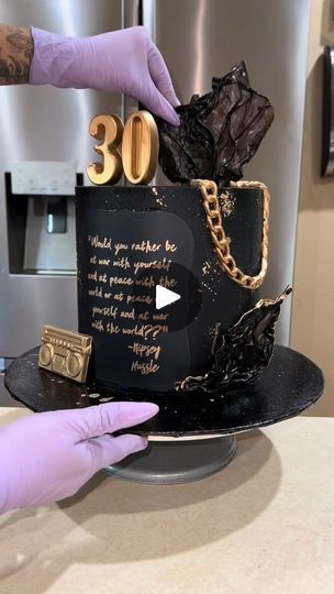 2.2K views · 99 reactions | Black and gold 30th birthday cake! #cakedecorating #30thbirthday #90sbaby  #cakevideo #c | Black and gold 30th birthday cake! #cakedecorating #30thbirthday #90sbaby  #cakevideo #c | By JV OM | This customer requested a cake
for her boyfriend's 30th birthday which I was super
happy to make because I also turned 30 this month. She told
me a few things that he likes but ultimately gave me creative
control. She knew that she wanted it to be a black and
gold cake. She mentioned he loves Oreos and he's really big
on nineties hip hop. She also gave me a Nipsey Hustle quote
that she wanted to include somewhere on the cake. And the
last thing she told me was make it elegant but dope. I knew
exactly where I wanted to go with this cake. So I started
out with a black butter Hip Hop Birthday Cake For Men, Black And Gold Cake For Men Birthday, Gold 30th Birthday Cake, Hip Hop Birthday Cake, 30th Birthday Cake Ideas, 30th Birthday Cakes For Men, Gold 30th Birthday, Black And Gold Cake, Hip Hop Birthday