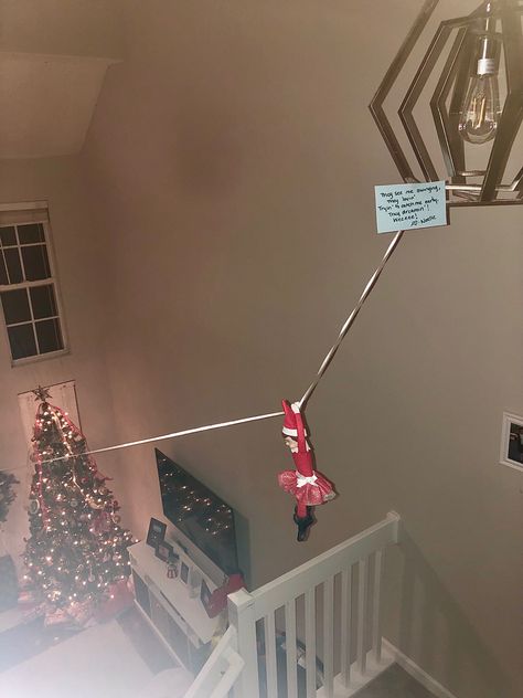 Always a favorite with my kid so we did it again. This time our elf is zip lining from the chandlier above the stairs to the stair wall that overlooks our living room. As always our elf had to leave a note. Elf On The Shelf Wall Climbing, Elf On Shelf Ziplining, Zip Line Elf On Shelf, Elf On The Shelf Stairs, Elf On The Shelf Stairs Ideas, Elf On The Shelf Leaving, Elf Zipline Ideas, Diy Zipline, Stair Wall