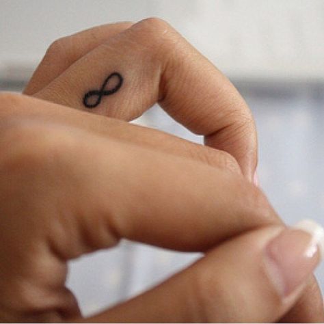 20 Infinity Sign Tattoos You Won’t Regret Getting: For anyone who has ever wanted a tattoo, you know that picking out the design is a difficult task. Infinity Finger Tattoos, Infinity Sign Tattoo, Inner Finger Tattoo, Finger Tattoos For Couples, Infinity Symbol Tattoo, 42 Tattoo, Small Finger Tattoos, Wedding Ring Tattoo, Tattoo Wedding Rings