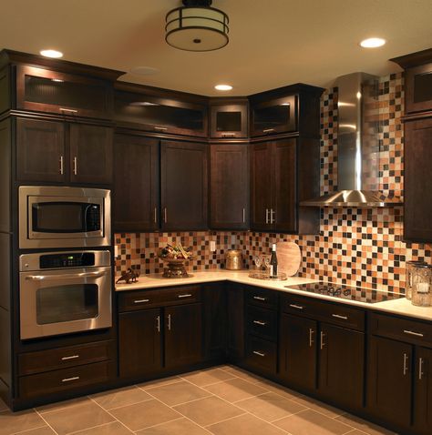 Get an original kitchen with dark wood cabinets, interior tiled walls and unique lighting from Craftsmen Home Inc. Dark Brown Kitchen Cabinets, Brown Kitchen Ideas, Dark Brown Kitchen, Espresso Kitchen Cabinets, Dark Brown Cabinets, Espresso Kitchen, Brown Kitchen Cabinets, Beautiful Kitchen Cabinets, Kitchen Cabinets And Countertops