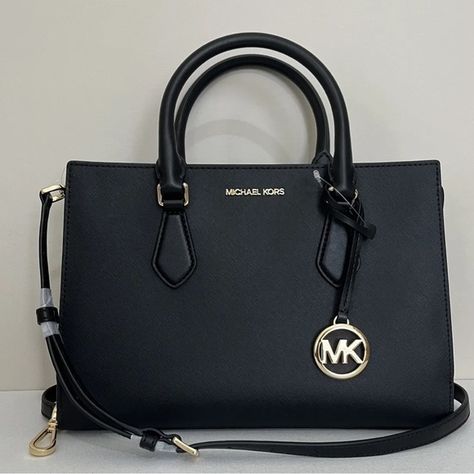 Shop amstar13's closet or find the perfect look from millions of stylists. Fast shipping and buyer protection. New with tags 100% Authentic Michael Kors Sheila Medium Saffiano Leather Satchel Black with Gold tone hardware Style# 35S3G6HS2L Elegantly streamlined, the Sheila satchel is a classic style you can carry all day and into the night. It’s crafted from faux Saffiano Leather with minimal hardware and has internal pockets for organizing your belongings. Carry it by the elegant top ha