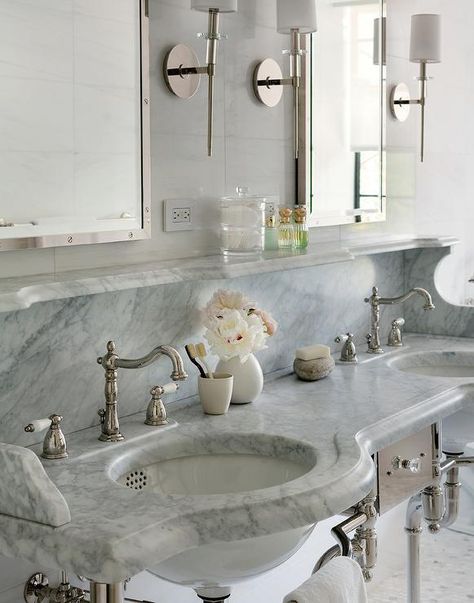 Two Restoration Hardware Rivet Medicine Cabinets stand over a marble double sink vanity fitted with his and her sinks and polished nickel vintage hook and spout faucets fitted with a marble backsplash and shelf. Shelves Styling, Marble Bathroom Decor, Marble Bathroom Designs, Vanity Backsplash, White Marble Bathrooms, Double Sinks, Bathroom Model, Console Sink, Bad Inspiration