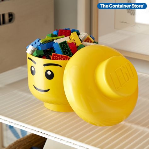 The recognizable, friendly smile of this LEGO head is sure to appeal to kids of all ages! They will love this iconic character for storing LEGO bricks, LEGO accessories, or anything else you need to store. Simply remove the top to access the storage space. The bright yellow color is sure to brighten up any playroom or child's bedroom making it not only a functional storage container, but a great decorating accessory as well. Closet Boxes, Lego Head, Lego Accessories, House Organization, Lego Room, Lego Storage, Lego Bricks, The Container Store, Cute Candy