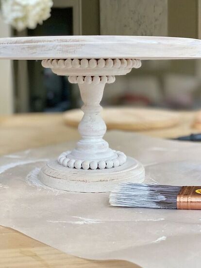 I love this wood cake stand so much. It was such an easy DIY and I think you might want to make one for sure! A few years I bought a wood cake stand that had beading and was painted white. I bought it at Magnolia in Waco and unfortunately they don’t sell it anymore. I get asked about the cake stand all of the time. So I decided to make one! The DIY How to Make a Wooden Cake Stand In the photo below, you can see the cake stand I bought at the Magnolia Market at the Silos. The… Wood Cake Stand Diy, Diy Cake Plate Stand, Cake Stand Diy, Wooden Cake Stand, Hype Beast Bedroom, Bedroom Decor Inspirations, Diy Cake Stand, Wooden Cake Stands, Wood Cake Stand