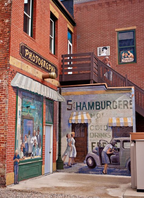 While visiting Downtown Owatonna, you will come across several street murals depicting the small town community’s history and heritage painted by local artists. These murals are hidden throughout the Historic Buildings! Can you find all of them? #murals #visitowatonna #downtown Town Mural, Historical Building Renovation, Heritage Paint, Exterior Murals, Building Renovation, Street Mural, American Painting, Water Tower, Old Buildings