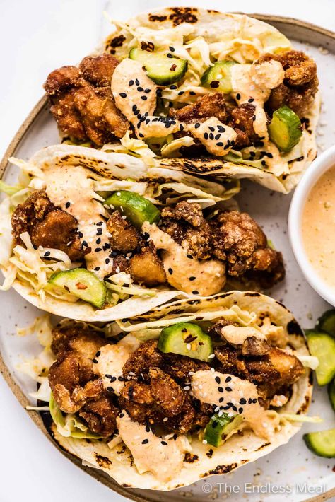 These chicken karaage tacos (AKA Japanese fried chicken tacos) are here to spice up your taco game in the best way possible! Warm tortillas are loaded with crispy pieces of karaage chicken, tangy quick-pickled cucumbers, and a creamy kimchi mayo sauce. They're simple to make and come together in just under an hour! #theendlessmeal #karaagechicken #chicken #tacos #chickentacos #karaage #koreantacos #japanesetacos #fusiontacos Kimchi Mayo, Fried Chicken Tacos, Asian Tacos, Fusion Tacos, Karaage Chicken, Fried Chicken Taco, Chicken Karaage, Japanese Fried Chicken, Japanese Chicken