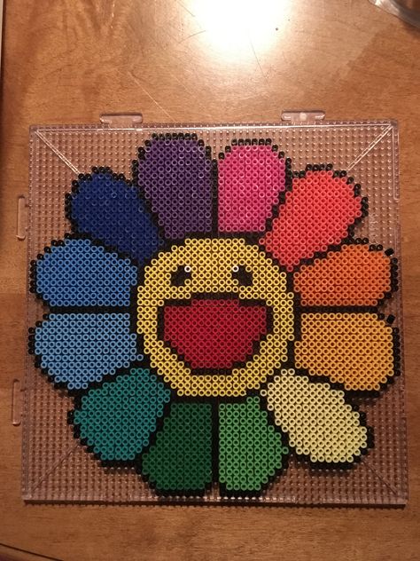 Takashi Murakami smiling flower in mini perler beads. Murakami Flower Pixel Art, Flower Perler Bead Pattern, Big Perler Beads Ideas, Peeler Bead Ideas Big, Smiling Flower, Hama Bead Flowers, Flower Pearler Bead, Flower Hama Beads, Smile Flower