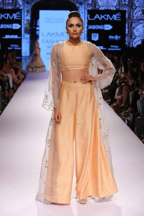 Payal Singhal debuted her latest collection at Lakmé Fashion Week with cream and nude lenghas galore. Spotted prints, peacock dupattas and fringed outfits filled her collection to the brim. She also included small jackets to accessorize her looks. Indian Crop Tops, Lakme Fashion Week 2015, Palazzo Pants Outfit, Jacket Crop, Gaurav Gupta, Payal Singhal, Shrug For Dresses, Julie Vos, Booties Outfit