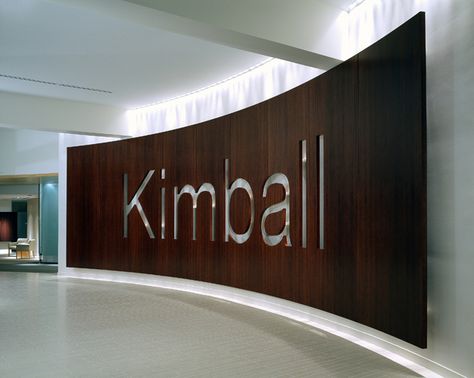 Kimball International - curved wood signage wall Lobby Logo Wall, Curve Wall Design, Office Logo Wall Design, Wall Signage Design, Office Logo Wall, Logo Wall Design, Logo On Wall, Large Signage, Education Design Interior