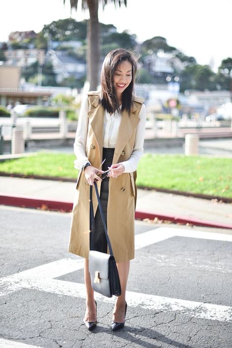 I can’t help but fall back on this simple recipe all too often: a white blouse (an essential), a pencil skirt (in this case, in leather or faux leather to add a little interest) and a trench coat (cool details on this one made it hard to resist). I enjoyed a quick little getaway to … Trench Vest Outfit, Sleeveless Coat Outfit, Sleeveless Trench Coat, Trench Vest, Sleeveless Trench, Trench Coat Outfit, Sleeveless Coat, Trench Dress, Summer Office