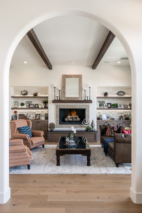 This timeless interior inspired by Spanish colonial architecture.   Fireplace Mirror by @indus.design Wall tile by @MonterreyTile Rug by @loloi Photo by @charliewalkercreative #deserthome #interiordesign #fireplacedesign #spanishcolonial Spanish Tile Fireplace, Colonial Library, Fireplace Focal Point, Spanish Fireplace, Spanish Colonial Architecture, Spanish Interior, Amber Interiors Design, Spanish Modern, Tile Fireplace